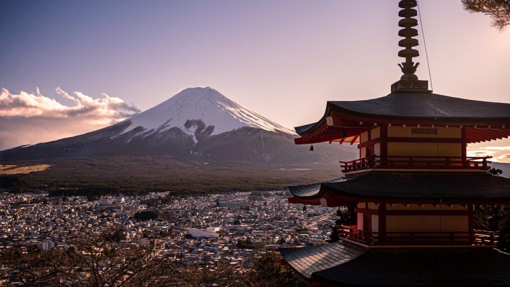 Japanese landscape of beautiful Chureito red Pagoda and Mt. Fuji with snow cover on the top at winter sunset. Fujiyoshida landmark travel place at Japan