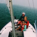 Grandfather sailing with grand kids