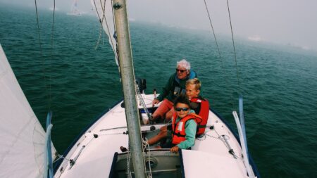 Grandfather sailing with grand kids