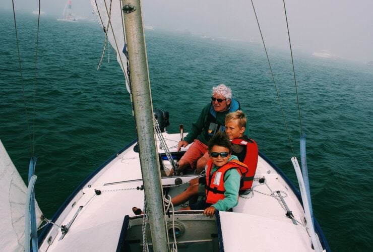 Grandfather sailing with grand kids