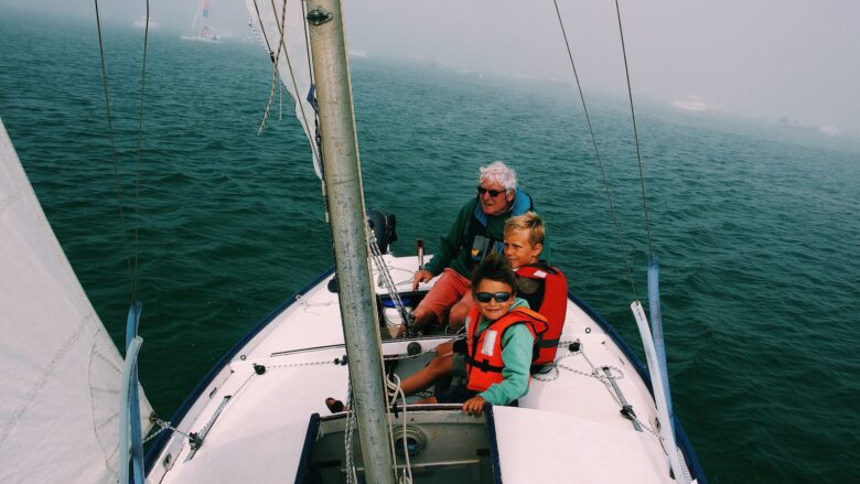 Grandfather sailing with grand kids