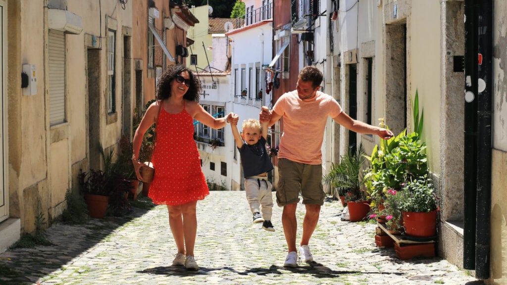 A family with a baby on vacation in Lisbon Portugal in the old town