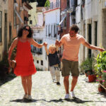 A family with a baby on vacation in Lisbon Portugal in the old town