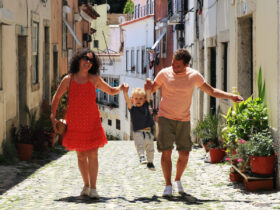 A family with a baby on vacation in Lisbon Portugal in the old town