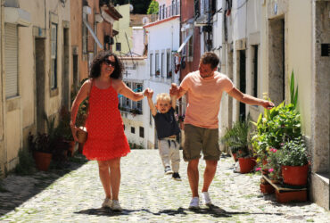 A family with a baby on vacation in Lisbon Portugal in the old town