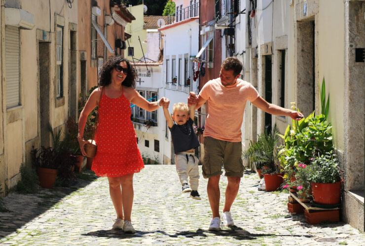 A family with a baby on vacation in Lisbon Portugal in the old town