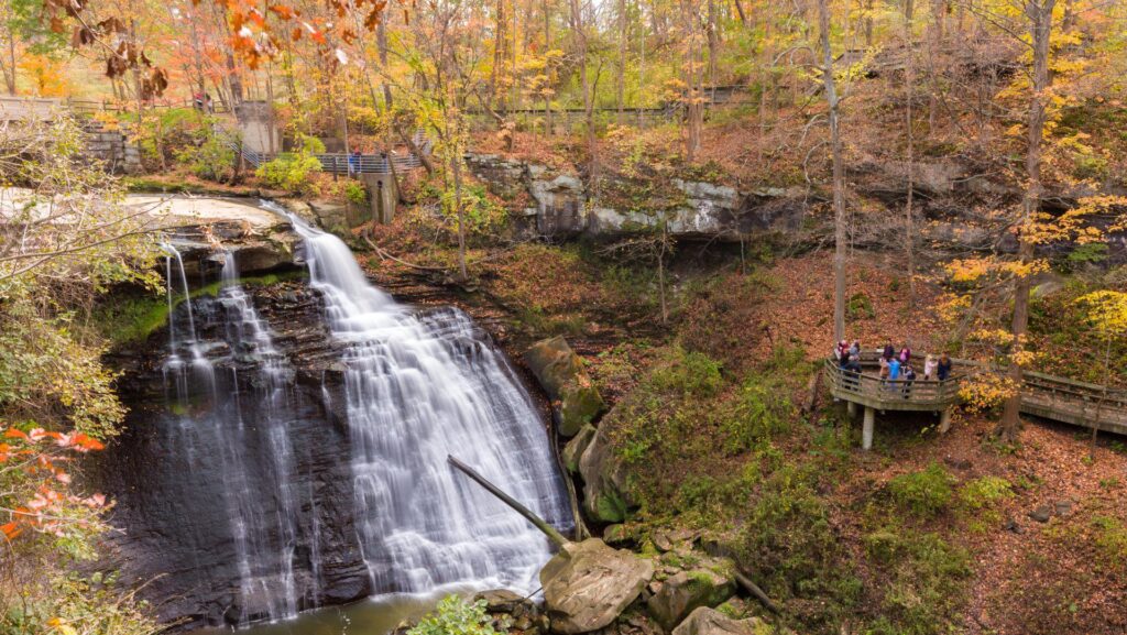 People admiring Brandywine Falls at Cuyahoga Valley National Park during the fall