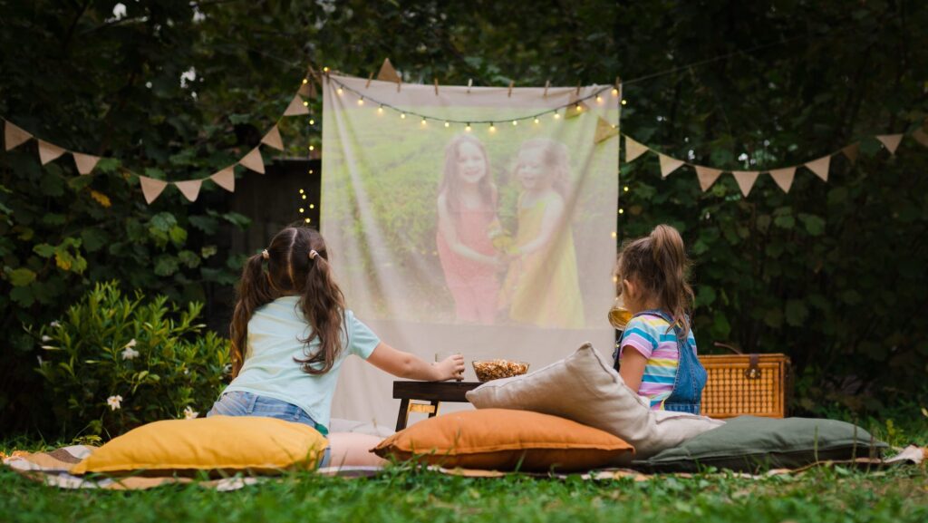 Backyard movie night with toddler and chlld