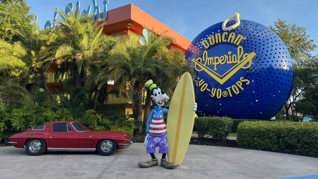 Photo op at Disney's Pop Century Resort with Goofy holding a surf board