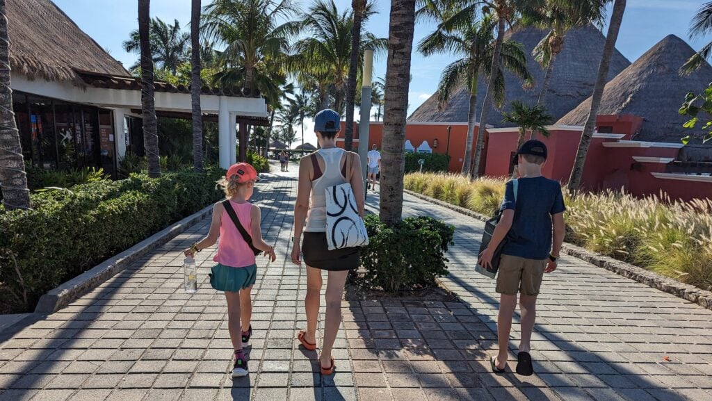 children walking with parent at a resort in Mexico
