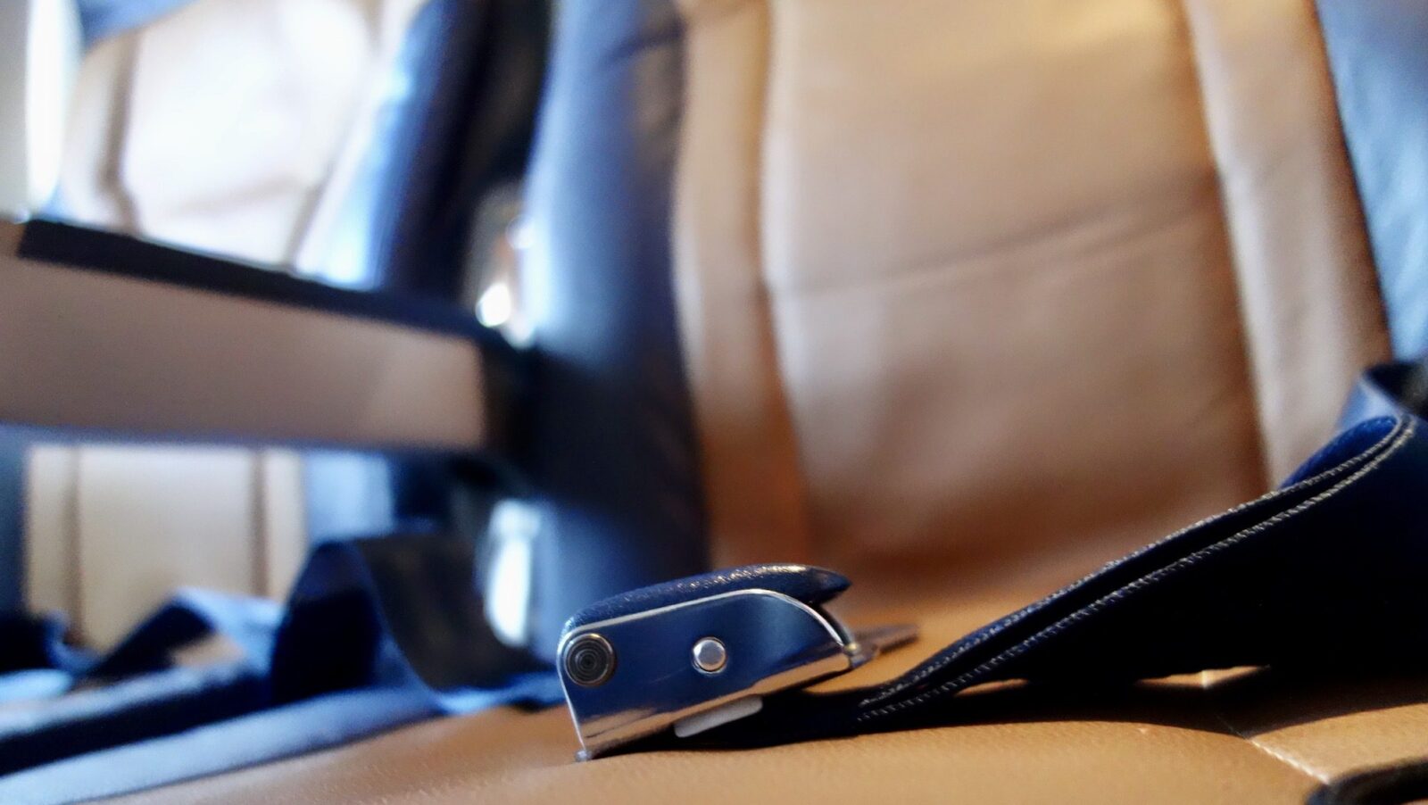 closeup of airplane seat and seatbelt