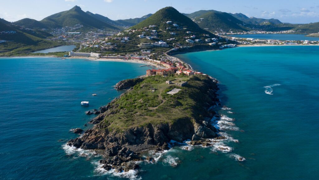 An aerial view of Fort Amsterdam with mountains behind it in St. Maarten