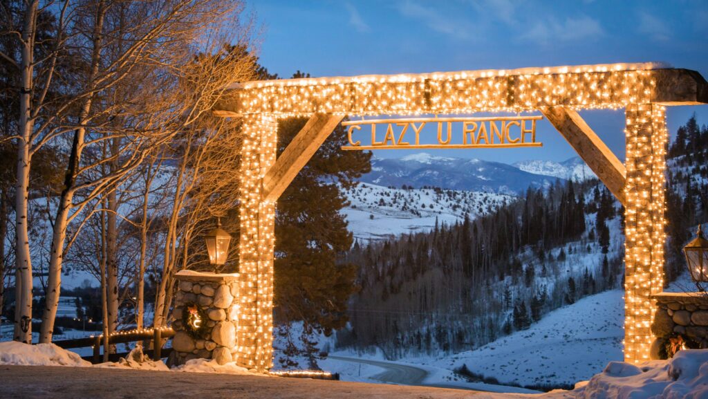 White Christmas lights on the entrance gate to C Lazy U Ranch