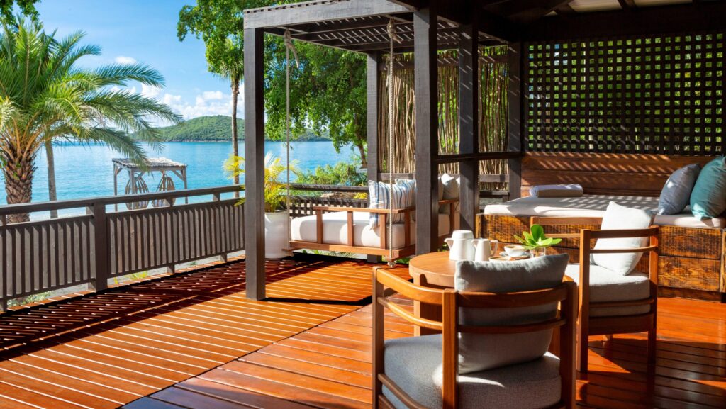The outdoor verandah at at Beachfront Villa Suites at Hermitage Bay overlooking the water