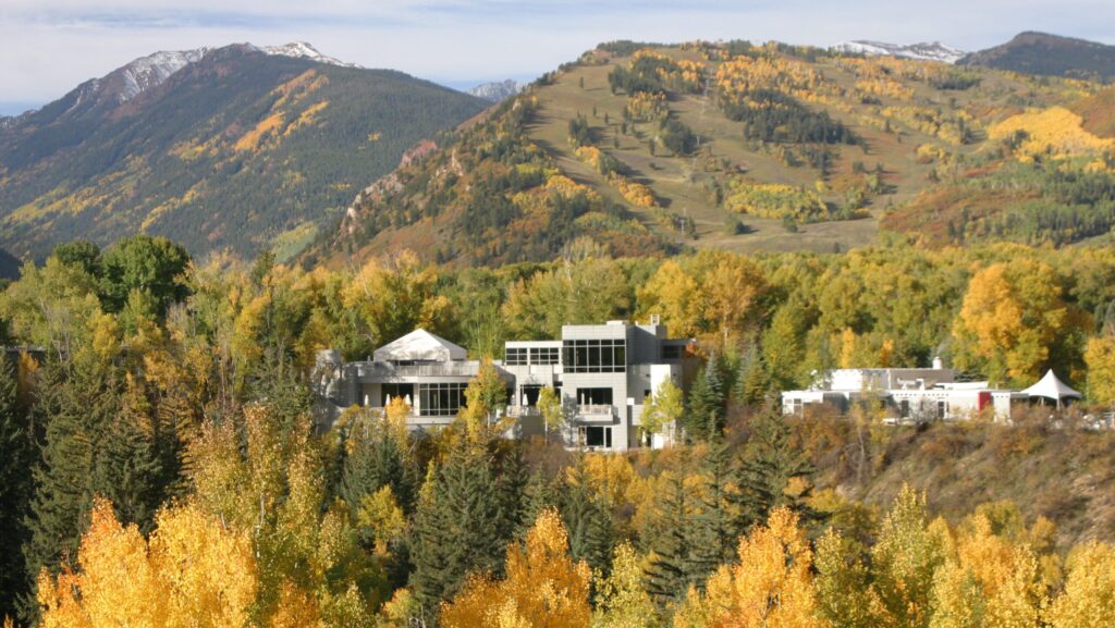 Aspens Meadows Resort with mountains in the background and fall foliage in the foreground