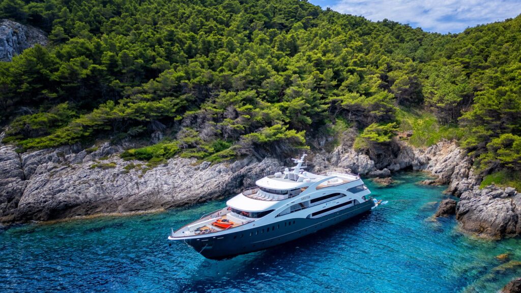 Cruise Croatia's Aretis vessel docked in a cove in turquoise water