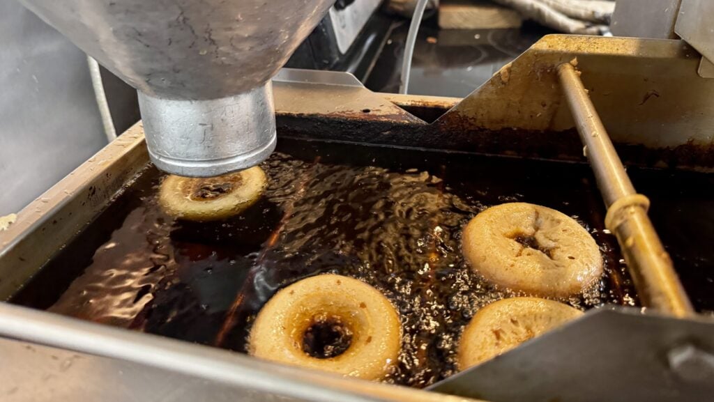Apple cider donut machine with apple cider donuts frying