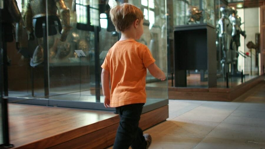 young boy walking through Musee de l'Armee