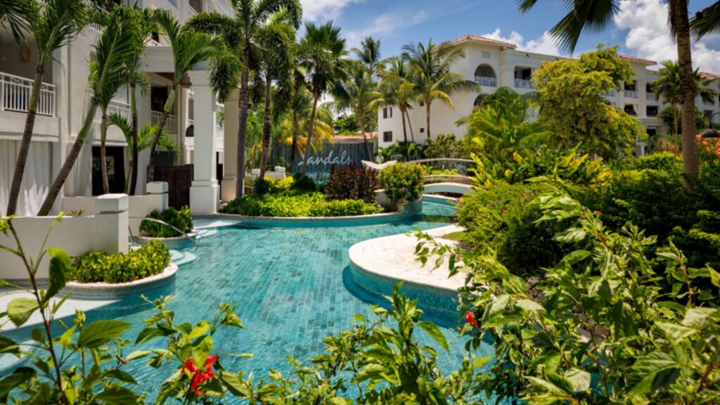 A view of the pool by some swim-up rooms at Sandals Barbados
