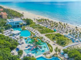 An aerial view of the beach, water park, and pools at Sandos Playacar