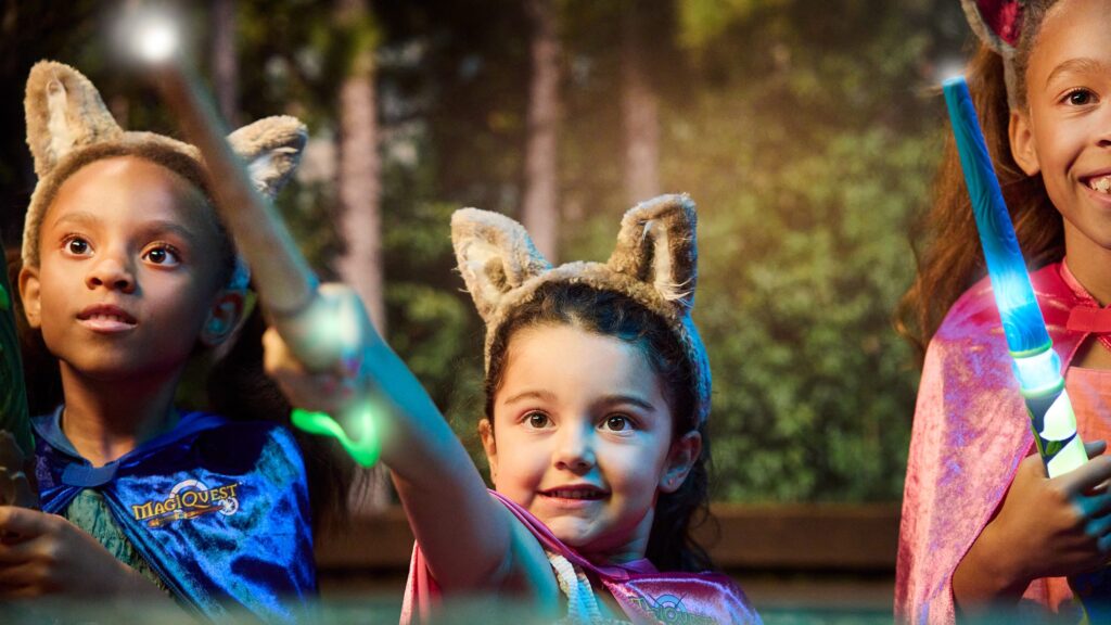 Three little girls doing the MagicQuest experience at Great Wolf Lodge