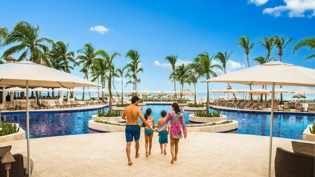Family Walking Pool Deck at Resort