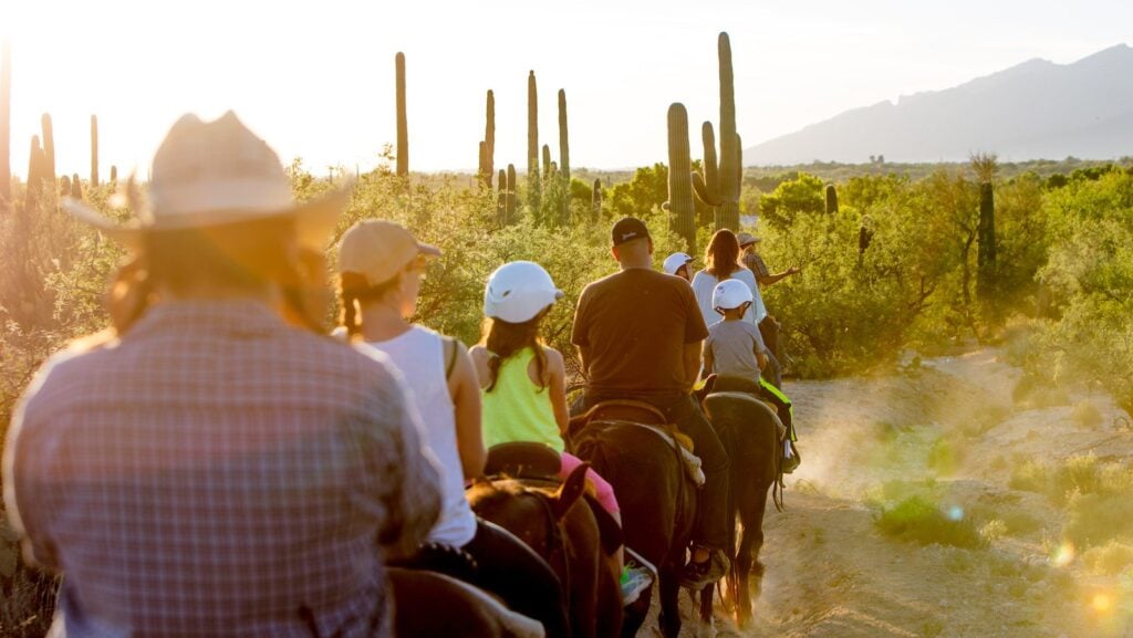Family riding horses at Tanque Verde Ranch