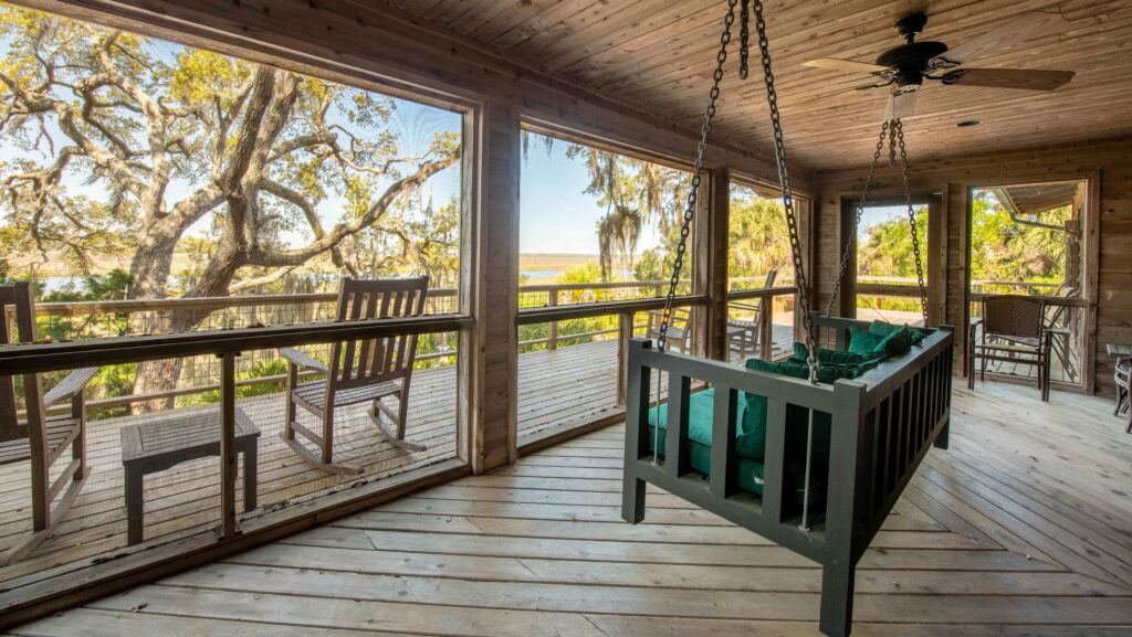 A porch swing in a cabin looking out over Little St. Simons Island