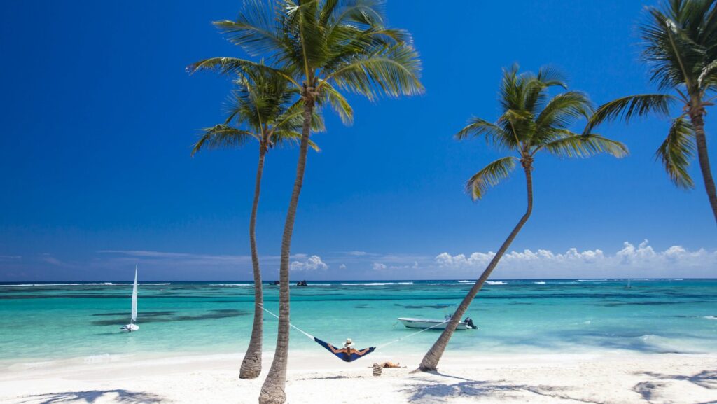 Person laying on hammock at Club Med beach location