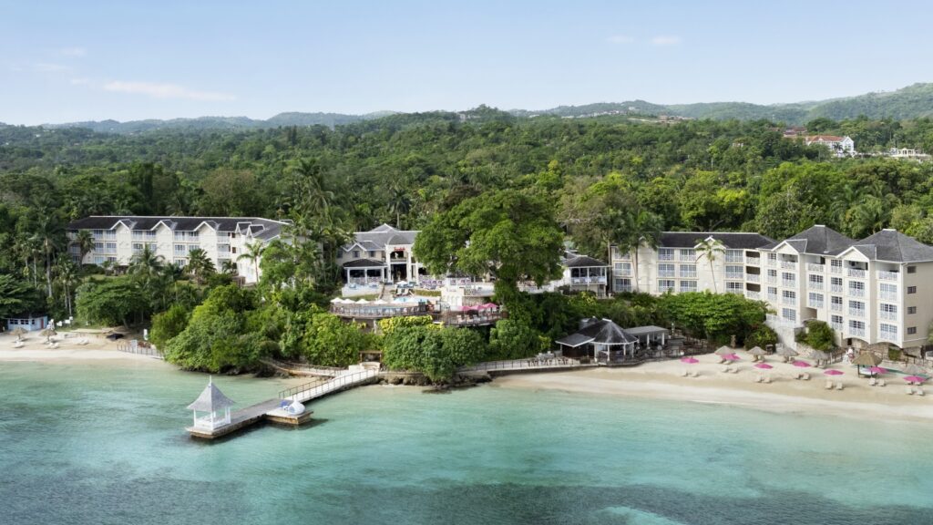 A drone image of the beach and some of the buildings at Sandals Royal Plantation