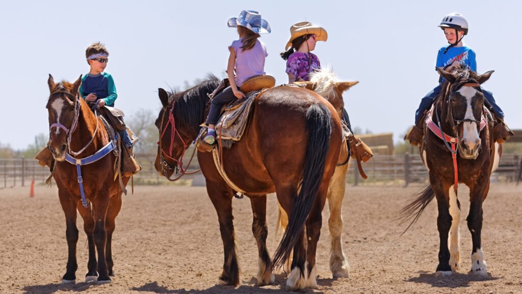 Four kids on horseback at White Stallion Ranch