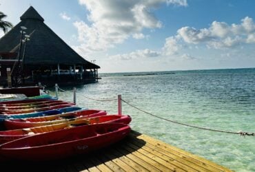 view of kayaks and restaurant along water at Club Med Cancun