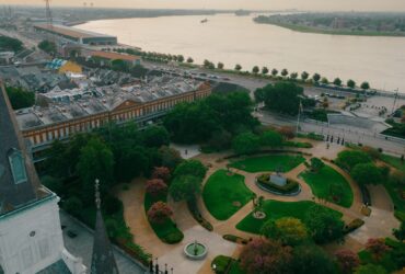 view of French Quarter and river in New Orleans with St. Louis Cathedral and Jackson Square in foreground