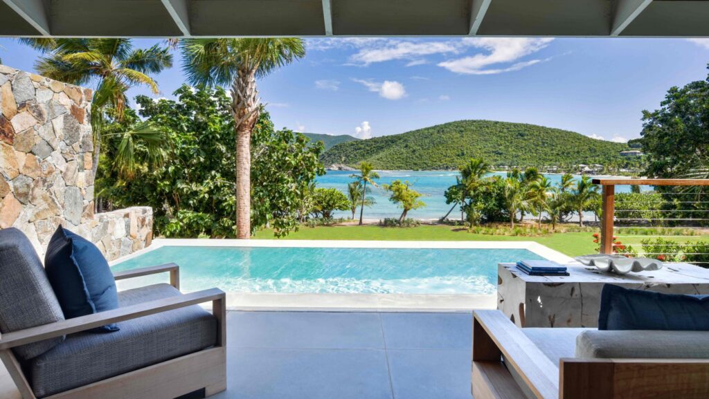 Chairs on a pool suite overlooking the ocean at Rosewood Little Dix Bay