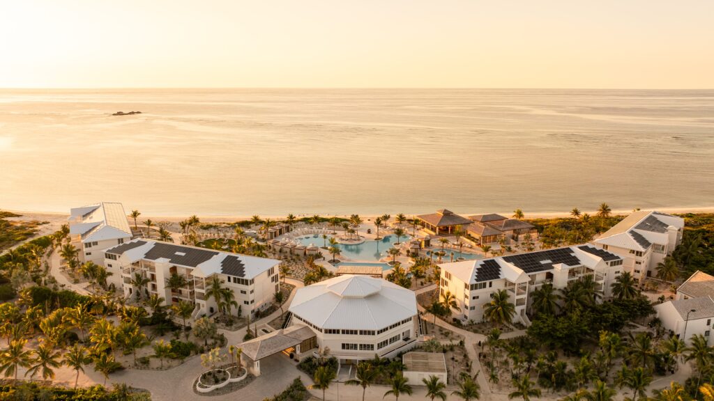 An aerial view of Salterra resort on South Caicos with a pool in the middle and a beach