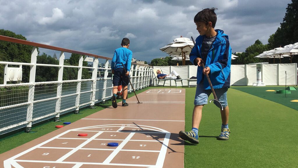 Kids playing top deck games on an A-Rosa European river cruise