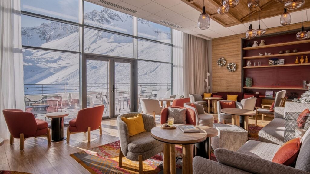 common area with comfortable seating near large windows onto the snowy mountain slopes