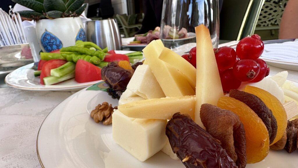 Traditional Turkish breakfast at Ciragan Palace Kempinski Istanbul with view of cheese, dates, and peppers