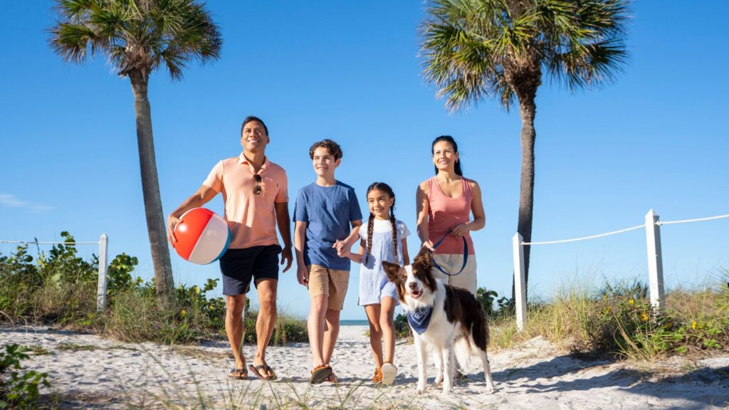 Family and dog on beach (Photo: TradeWinds Island Resort)