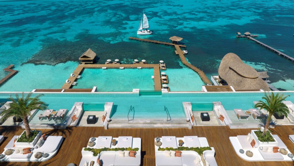 An aerial view of pools and the ocean at Impression Isla Mujeres by Secrets 