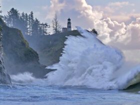 king tide crashing against the rocks below a lighthouse on Long Beach Peninsula in Washington state