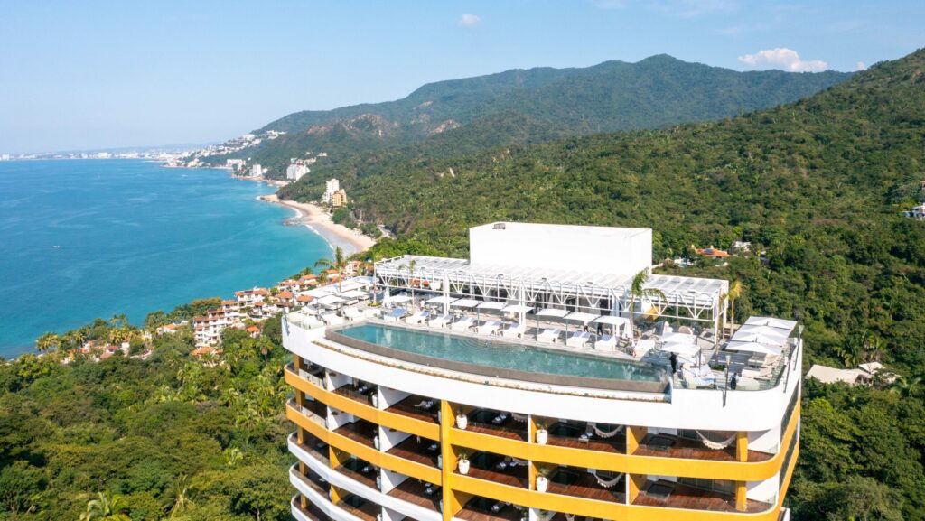 An aerial view of a rooftop pool and the beach at Hotel Mousai Puerto Vallarta