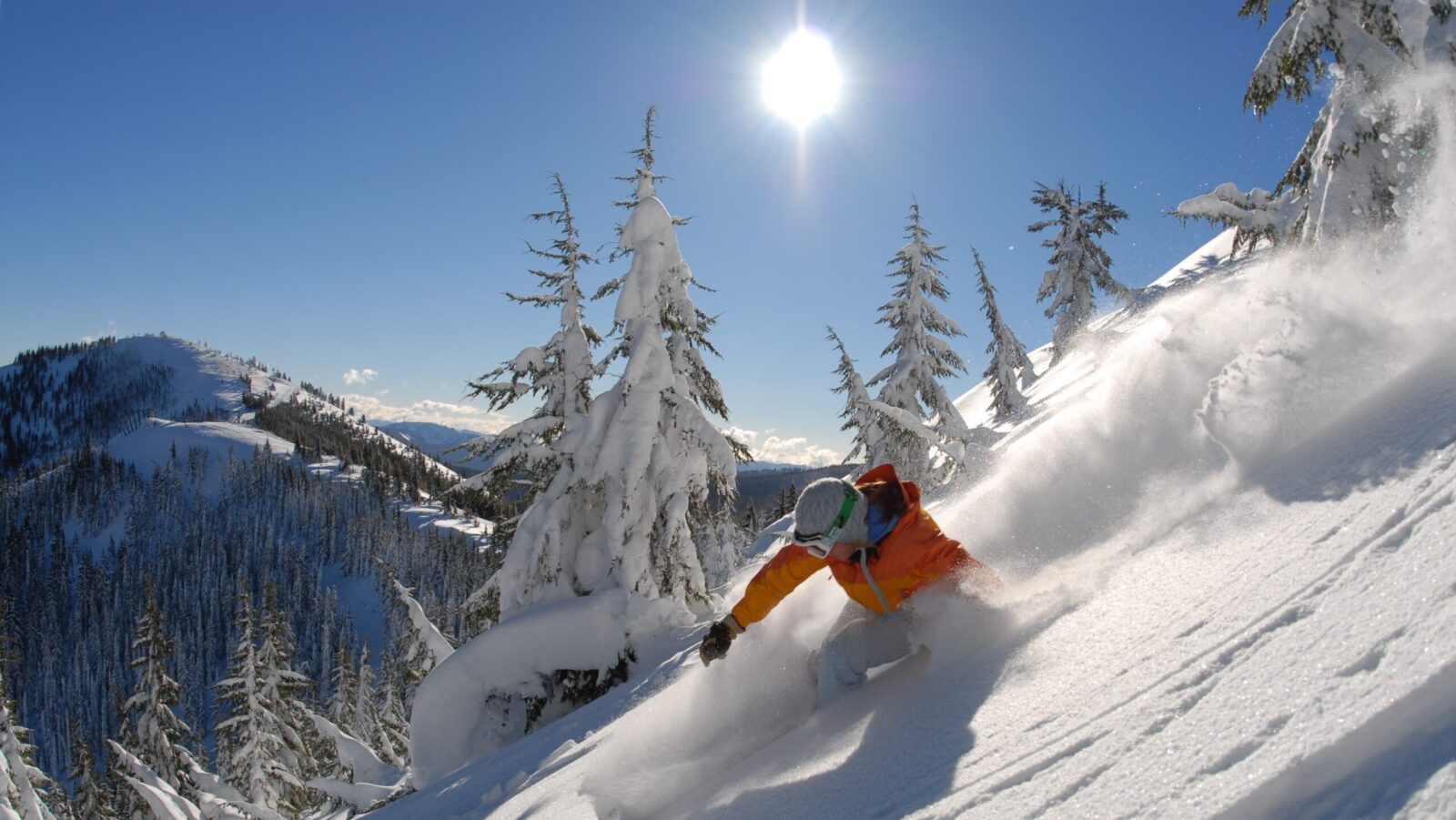 Silver Mountain Resort skier swooshing down a mountain on a sunny winter day near Coeur d'Alene