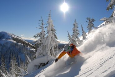 Silver Mountain Resort skier swooshing down a mountain on a sunny winter day near Coeur d'Alene