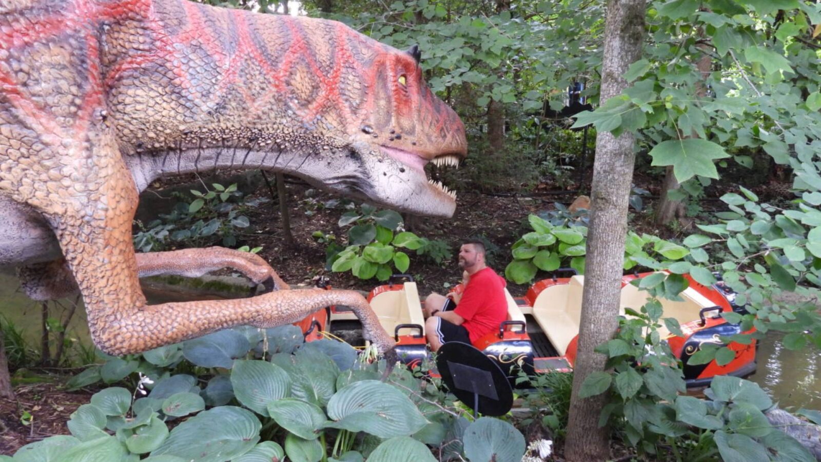 Passengers on boats encounter dinosaurs at the Columbus Zoo and Aquarium. Photo by Tim Trudell