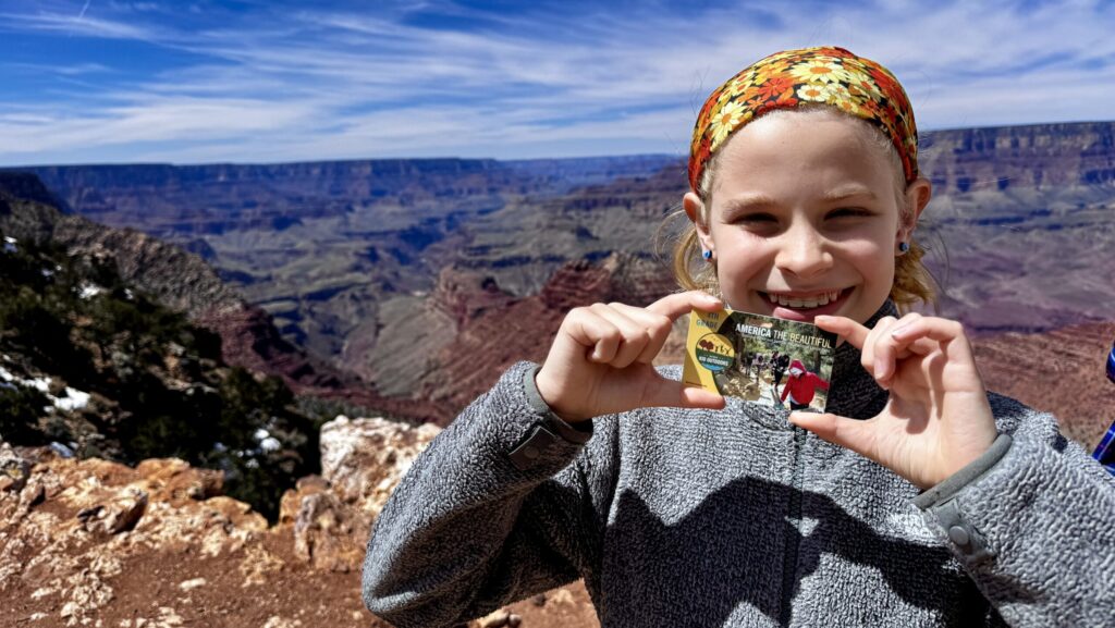 child holding fourth grade national parks pass