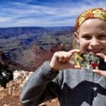 child holding fourth grade national parks pass
