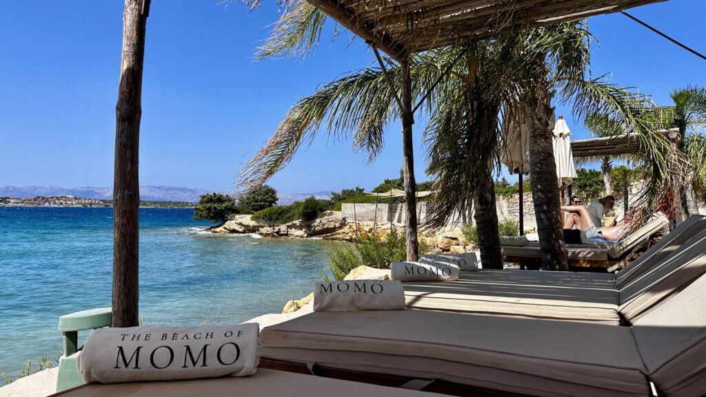 beach loungers along the water at Beach of Momo beach club near Alacati, Turkiye 