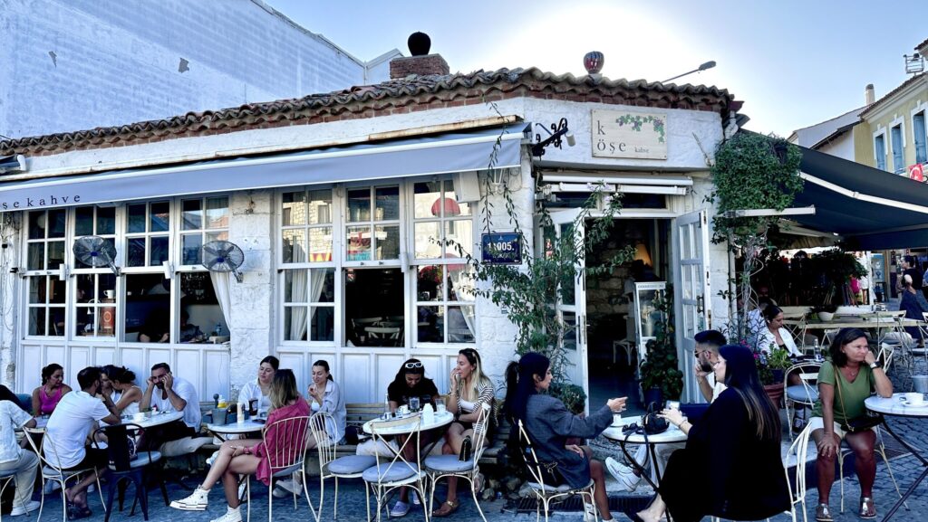 people hanging out at an outdoor cafe in Alacati, Turkey