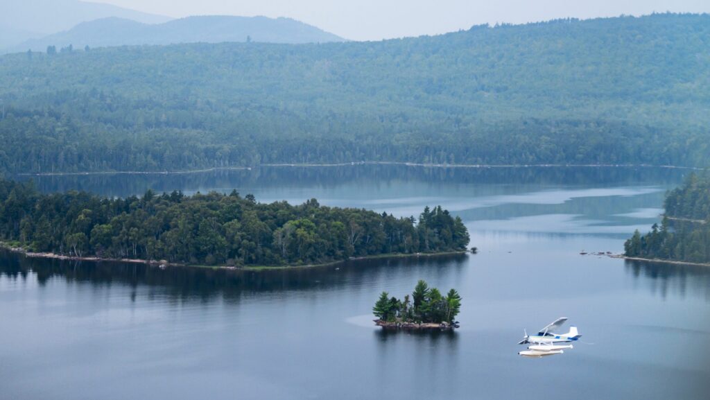 A seaplane flying over Lake Rangeley in Maine